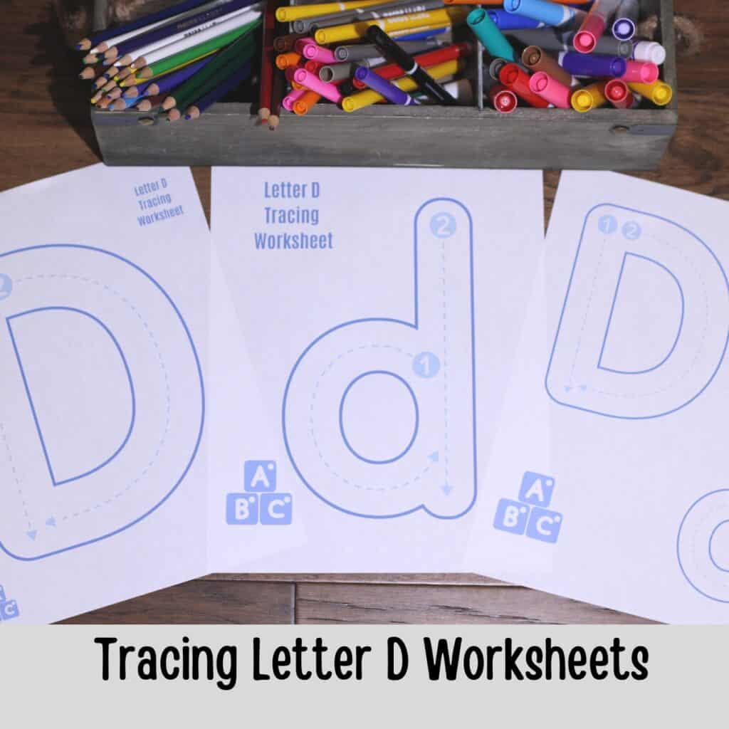 letter d tracing worksheets on a table with markers and colored pencils